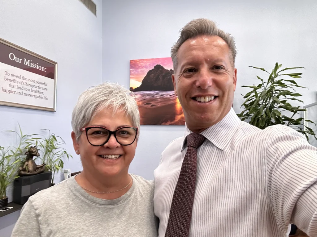 Dr. with happy patient inside clinic – On Purpose Chiropractic